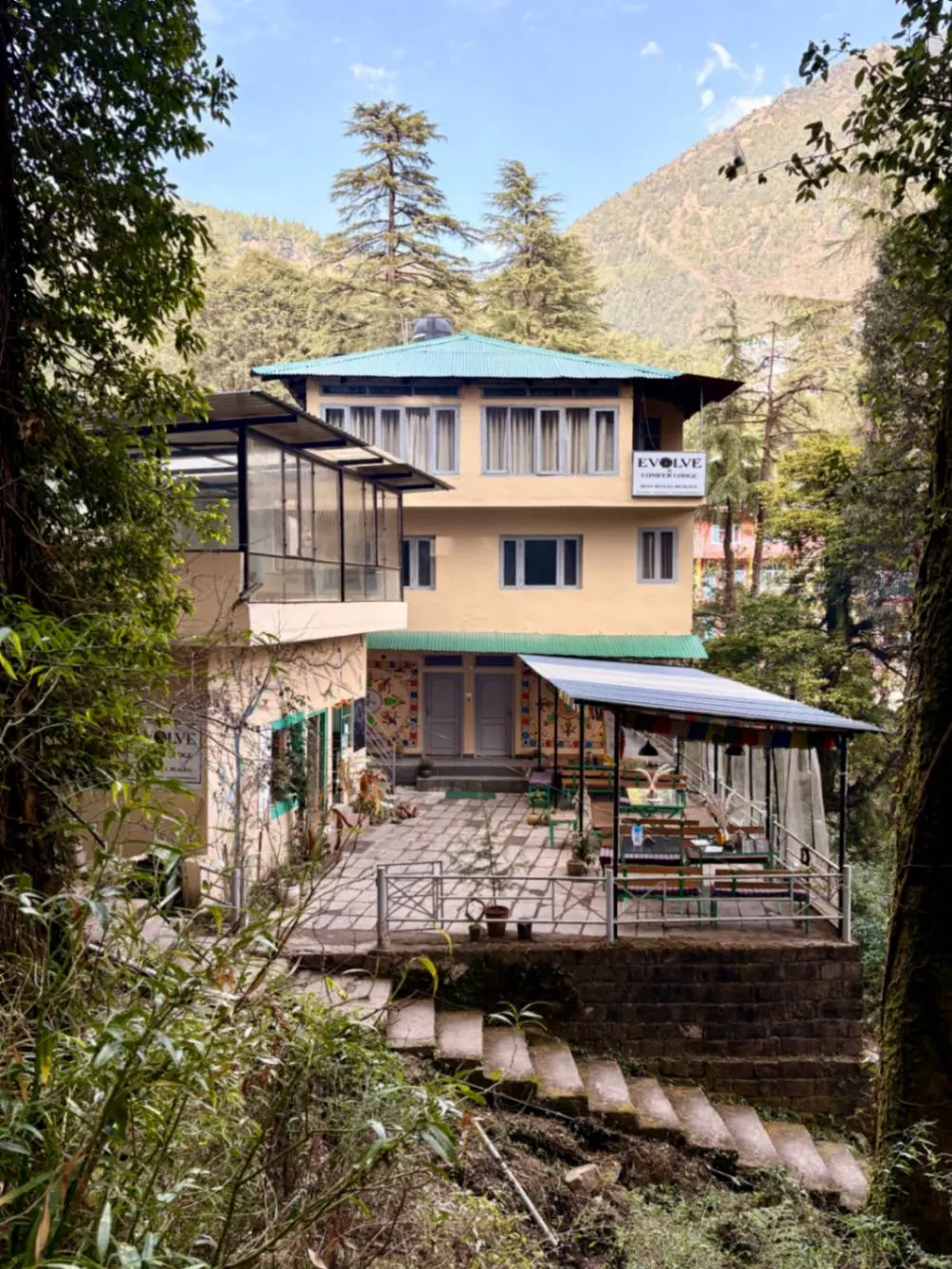 The wooden deck and terrace on the lower level of the hostel