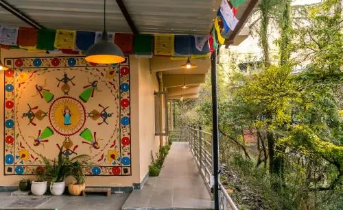 A painted mural and prayer flags along the open walkway
