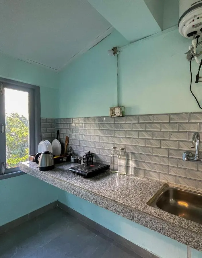 The kitchenette counter with sink and kettle