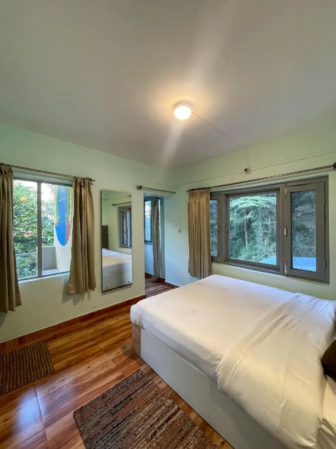 A private room with a large window looking into the forest