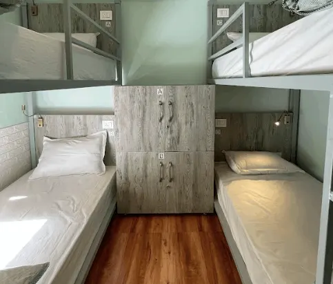 Single beds and lockers in the four-bed female-only dorm