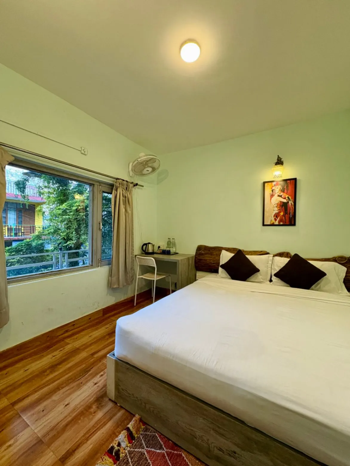 A king room with a wide bed and a window onto the valley